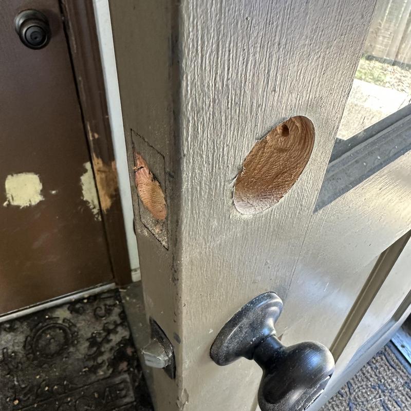 Door lock holes drilled for new lock installation