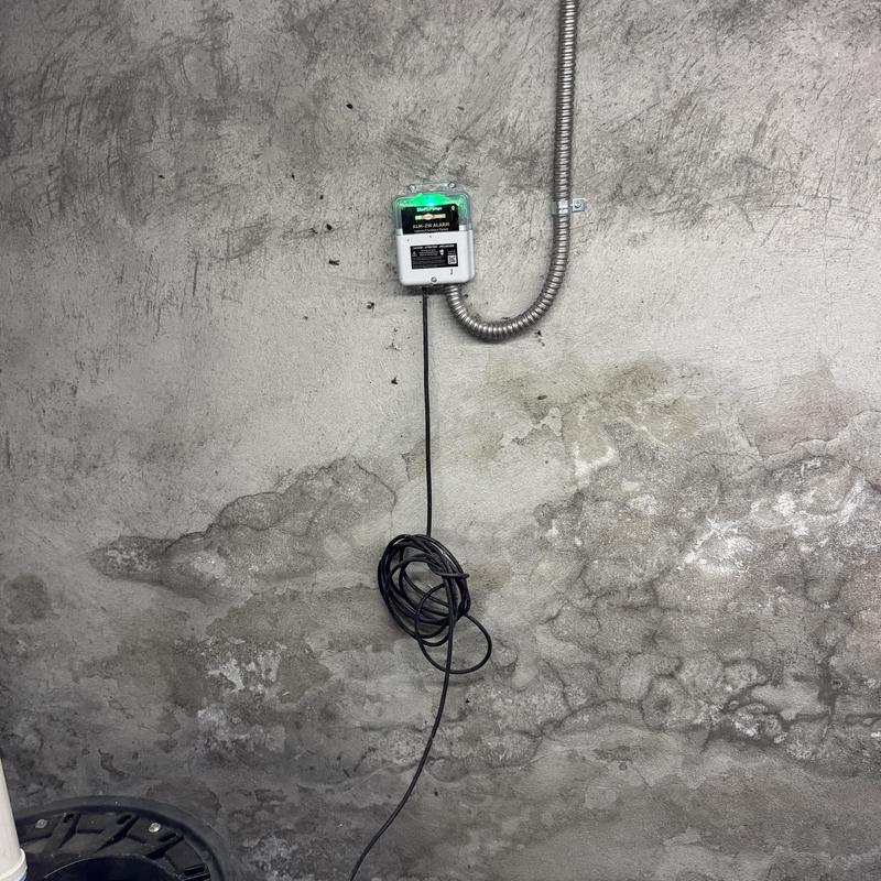 Sewage ejector pump alarm system on concrete wall
