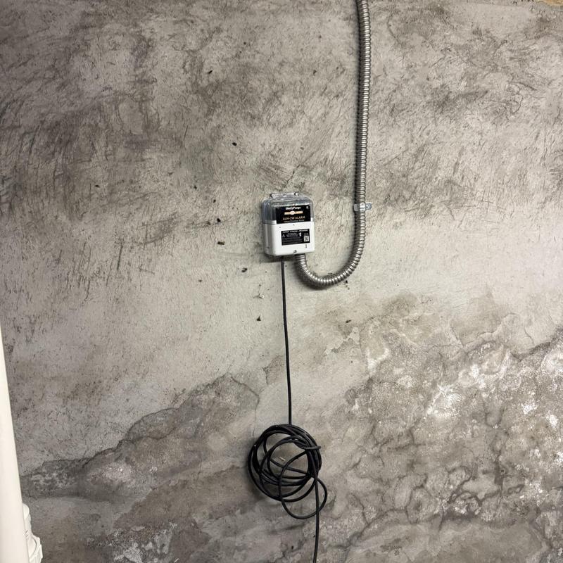 Sewage ejector pump alarm control box on wall