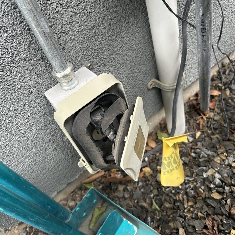 Damaged exterior electrical outlet bubble cover on home