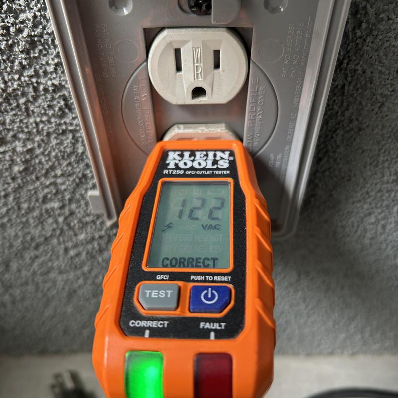 Exterior GFCI outlet voltage test shows correct reading