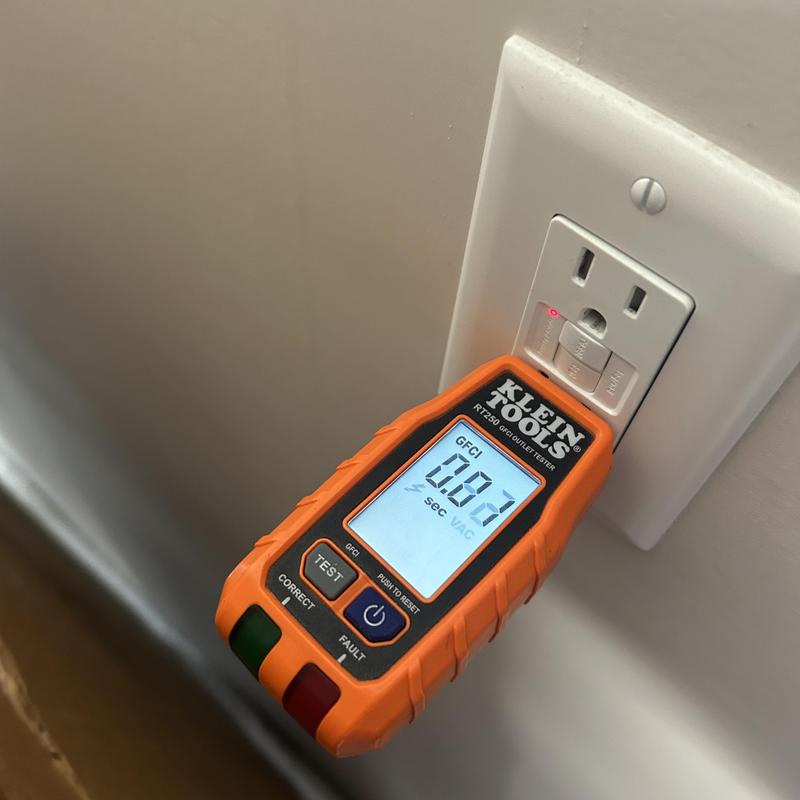 GFCI outlet tester checking wall receptacle function