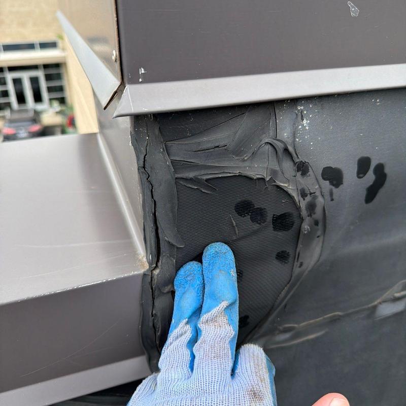 EPDM roofing membrane peeling near roof curb flashing