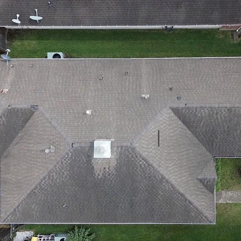 Architectural shingle roof with vent and chimney top view
