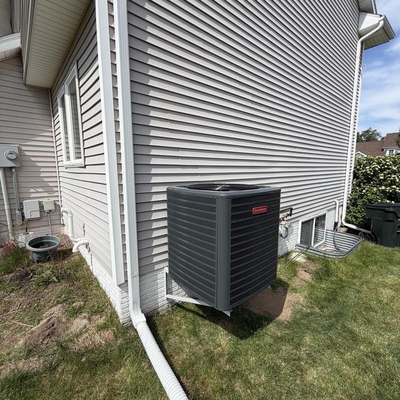 Goodman 15 SEER air conditioner installed outside house