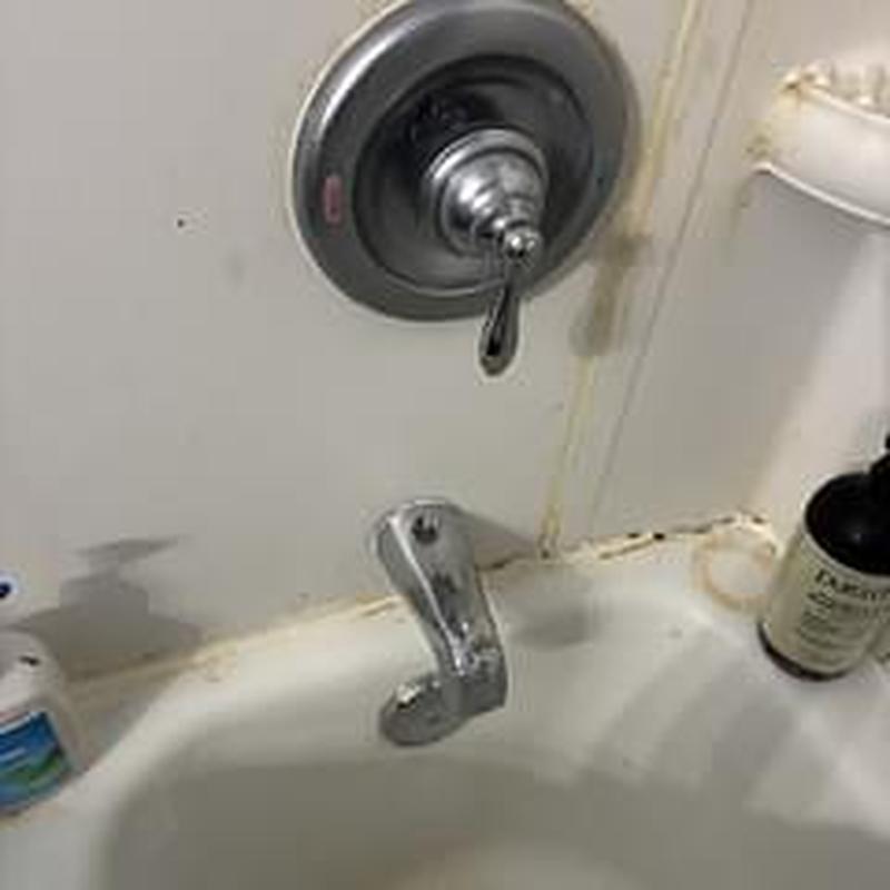 Tub spout and valve installation with surrounding wall stains Tub spout and valve installation with surrounding wall stains