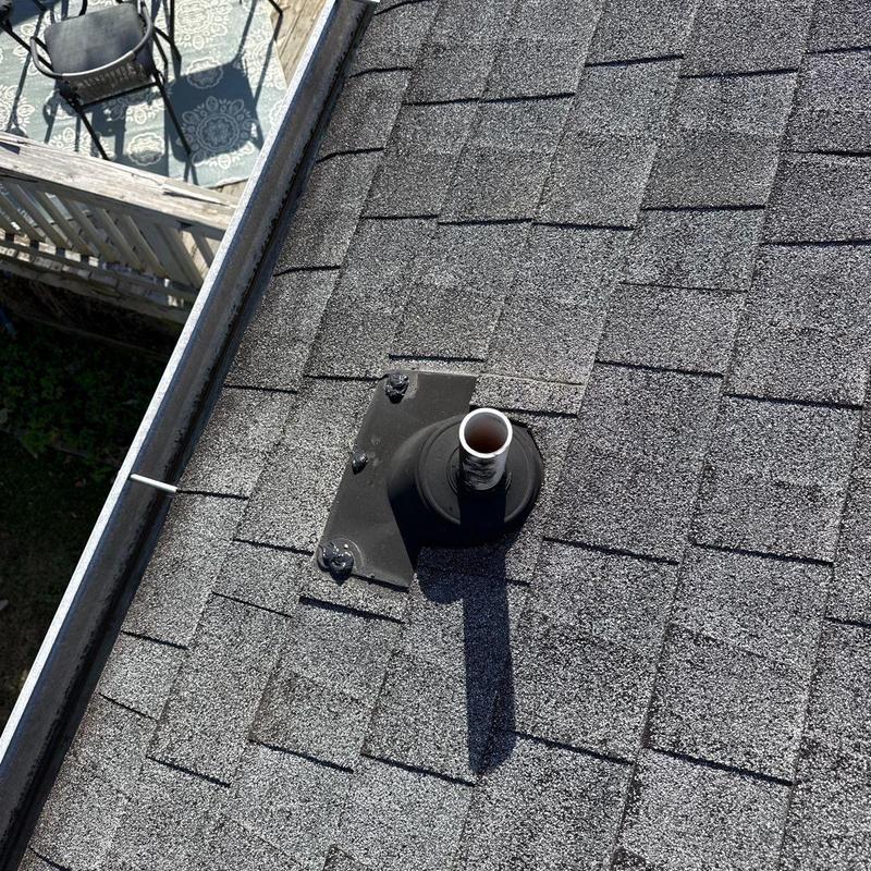 Asphalt shingle roof with vent pipe flashing and gutter