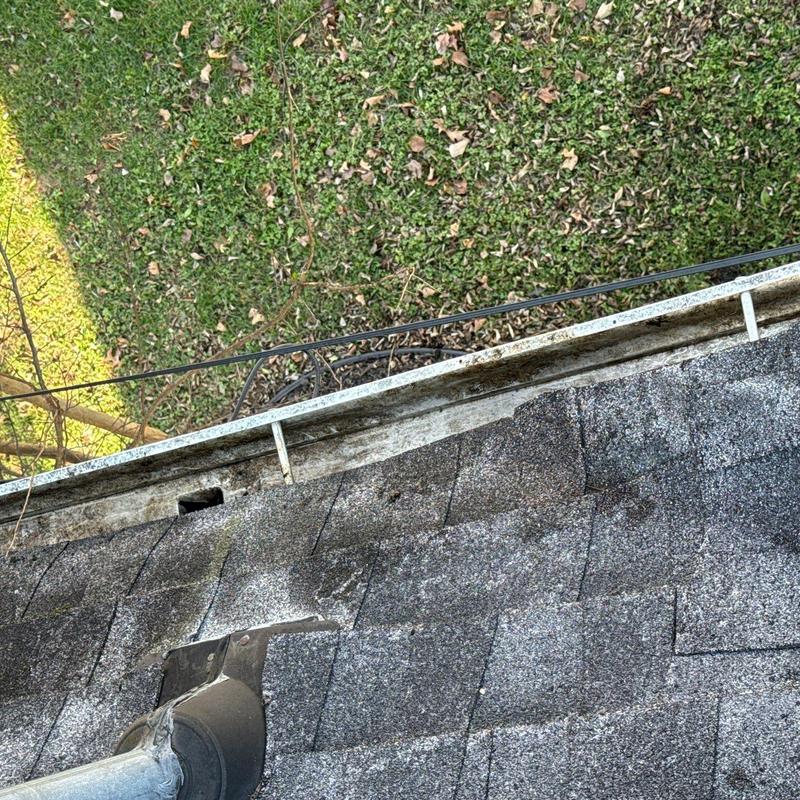 Asphalt shingles with hail damage near gutter system