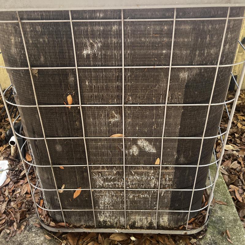 Outdoor AC unit coils heavily clogged and impacted