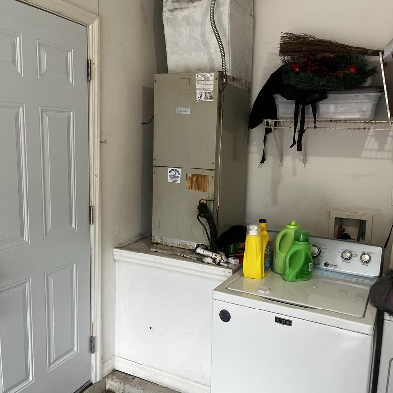 HVAC return duct with water and detergent bottles nearby