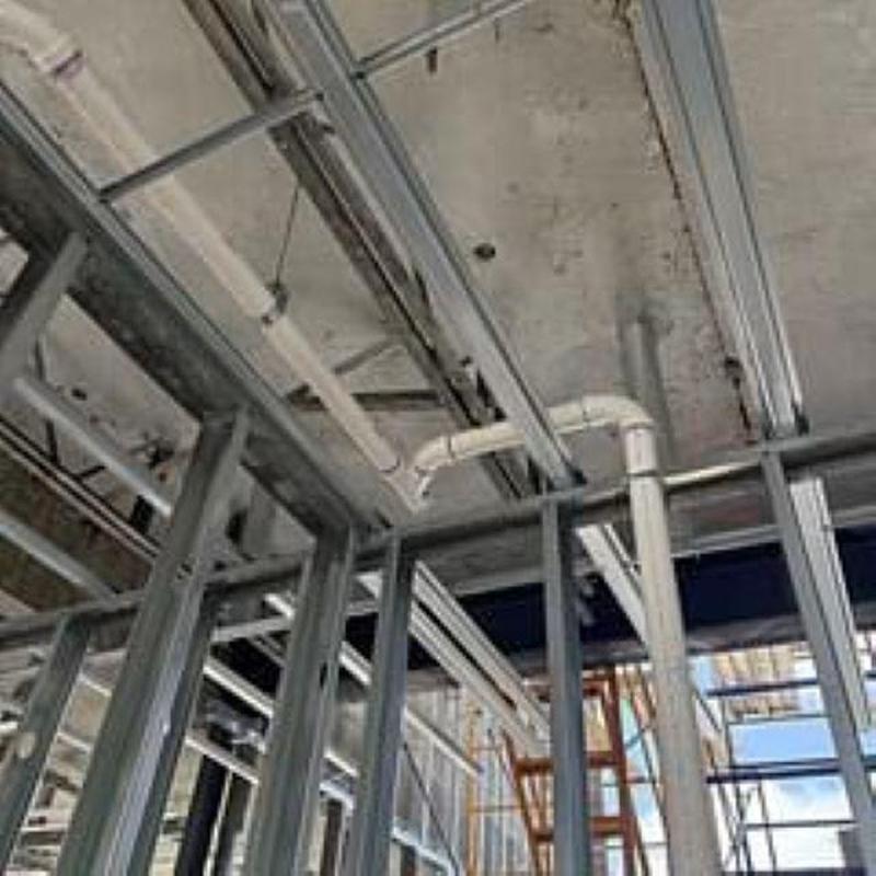 Sanitary drain and vent PVC piping in metal framing