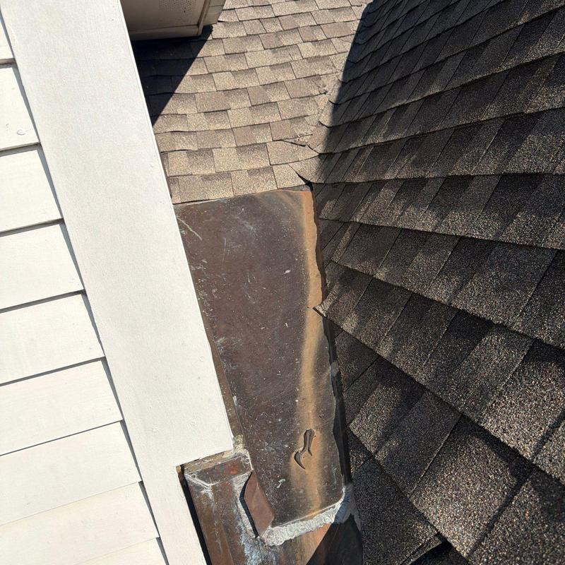 Roof flashing with visible wear and seam damage
