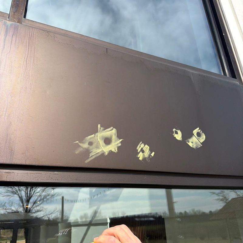 Metal flashing with marked hail damage on roof section