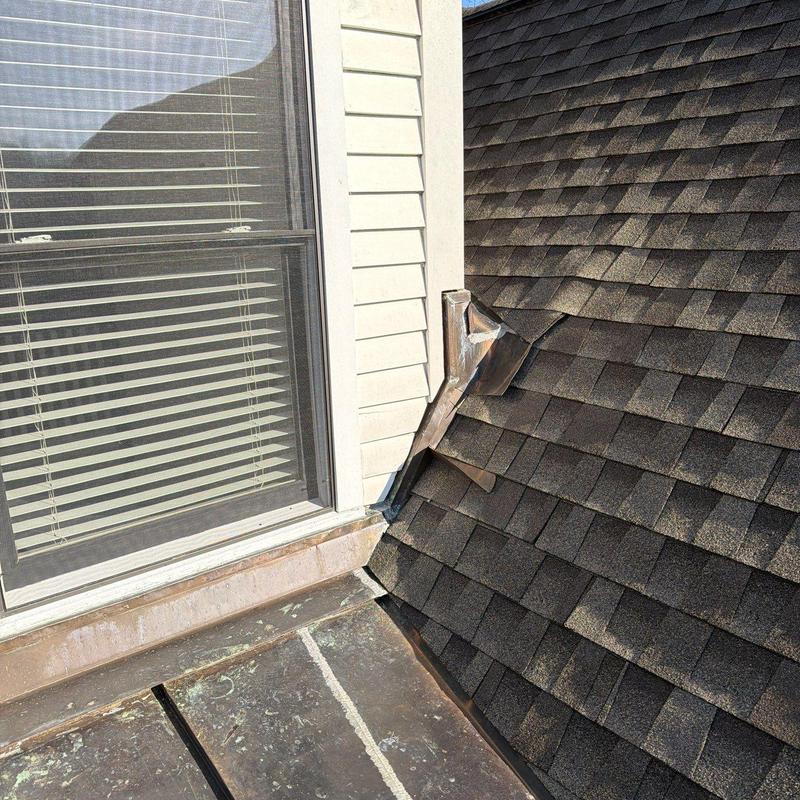 Flashing and shingle roof joint with metal cap detail