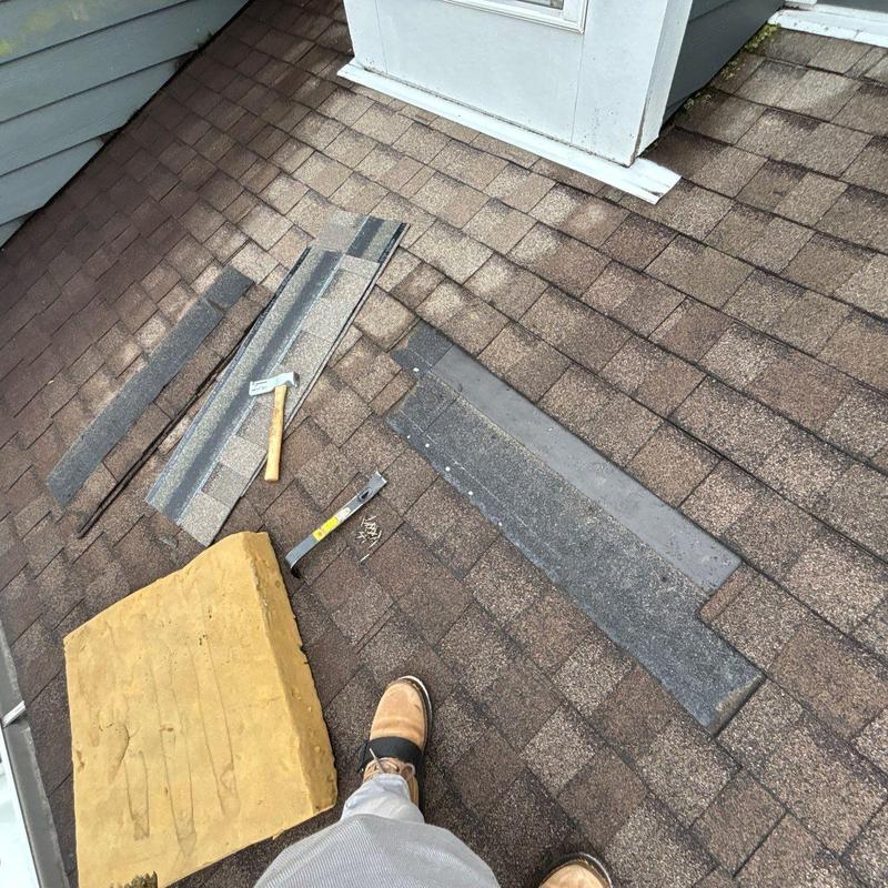 Asphalt shingles roof with repair tools and materials