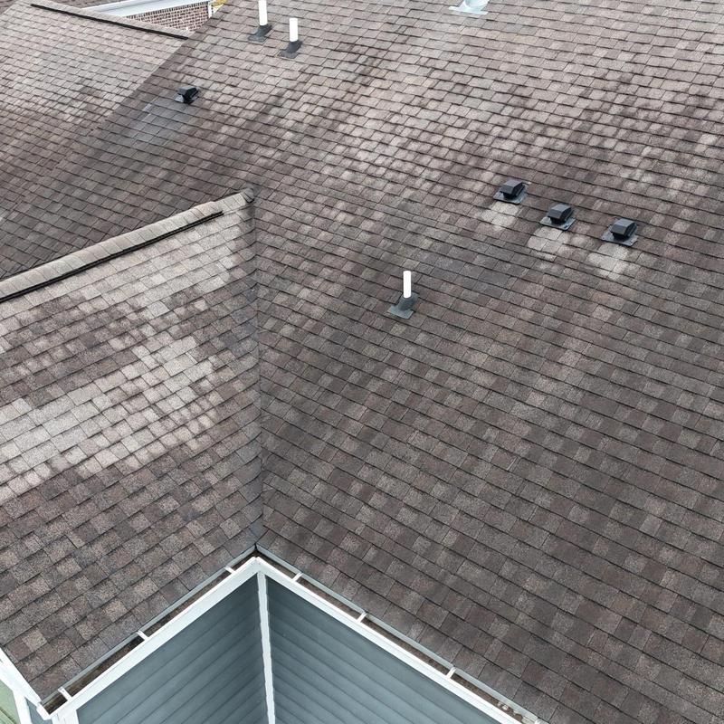 Asphalt shingle roof with vent pipes and flashing inspection