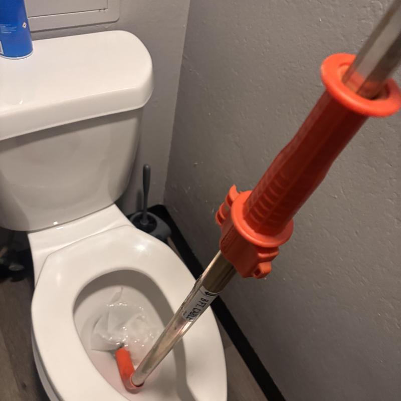 Toilet main line with drain snake during backup service