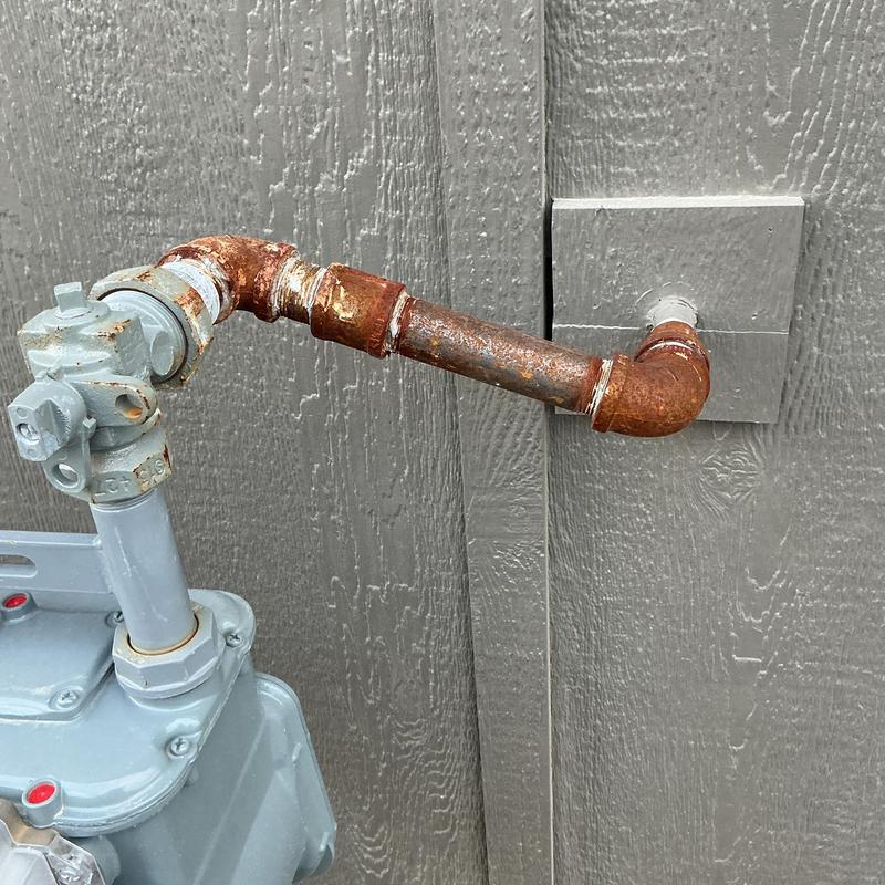 Gas line drip leg and rusted pipe connections outside
