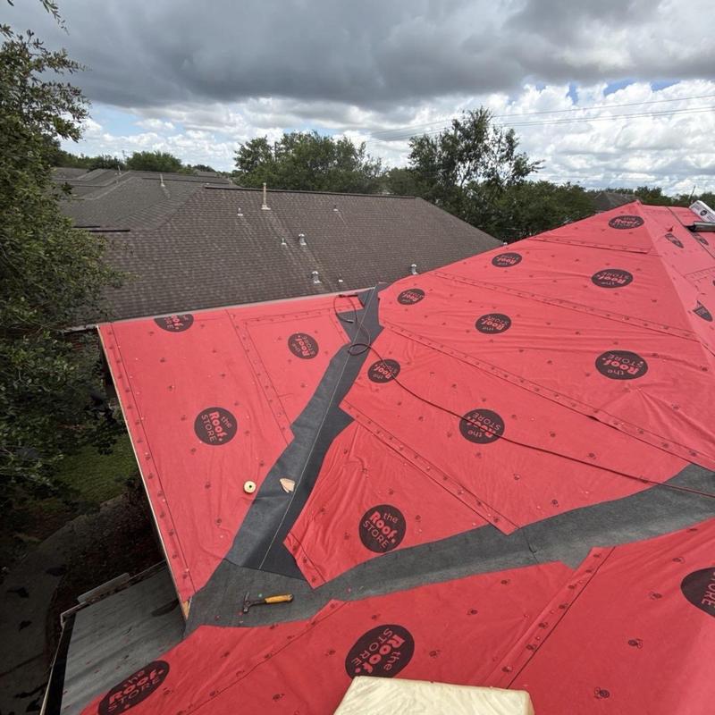 Synthetic roofing underlayment installation on residential roof