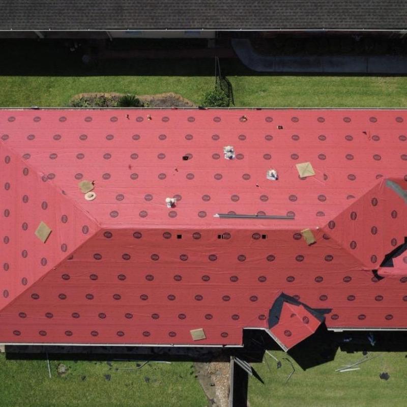 Synthetic roofing underlayment installation on residential roof