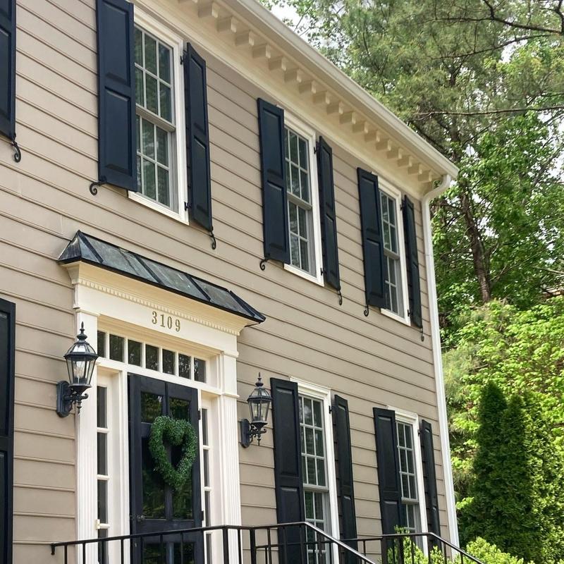 Exterior siding and trim with black shutters and door Exterior siding and trim with black shutters and door