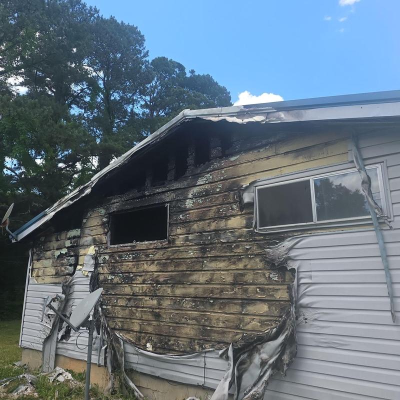 House siding fire damage and melted vinyl exterior