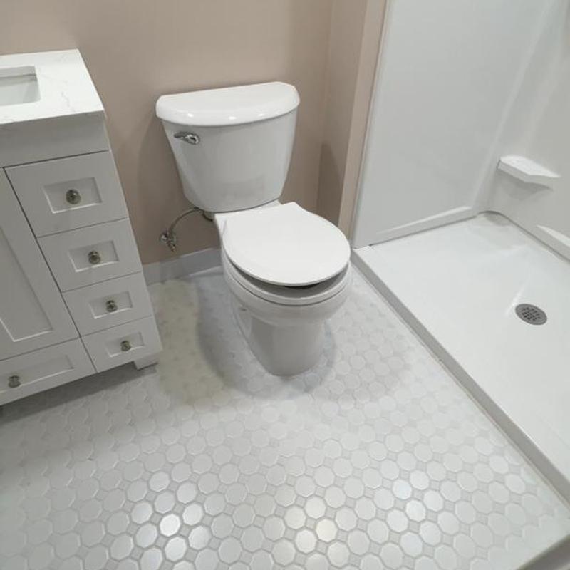 Toilet and shower base in bathroom remodel