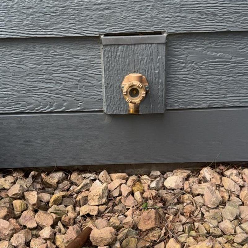 Outdoor water spigot replacement on siding panel