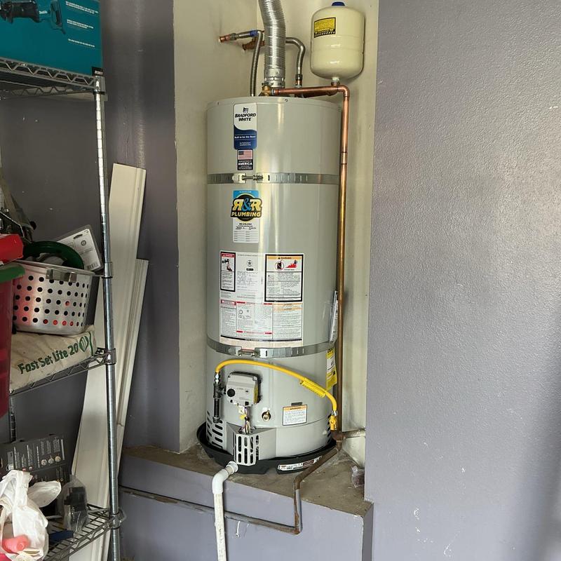 Water heater with gas line and sediment trap installed