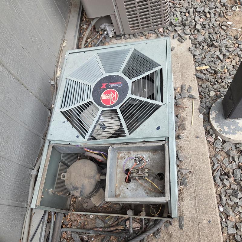 Rheem outdoor air conditioner unit with exposed wiring Rheem outdoor air conditioner unit with exposed wiring