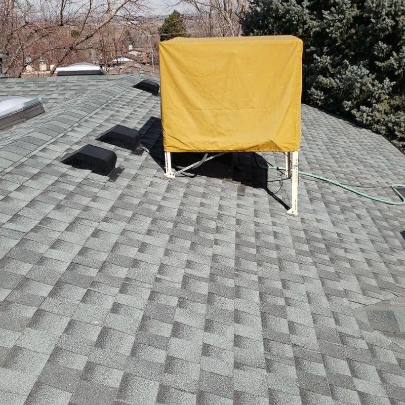 Swamp cooler on shingle roof with vent covers Swamp cooler on shingle roof with vent covers