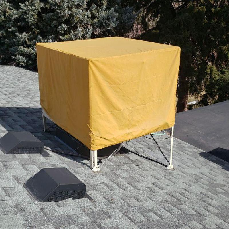 Swamp cooler on shingle roof with vent covers Swamp cooler on shingle roof with vent covers