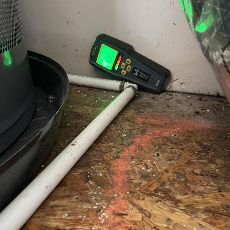 Water heater leak detector by piping on wood floor