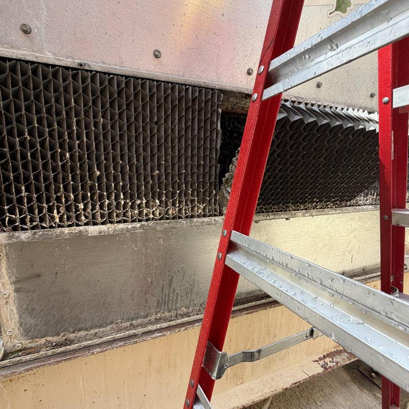 Cooling tower fill media damage with red ladder nearby Cooling tower fill media damage with red ladder nearby