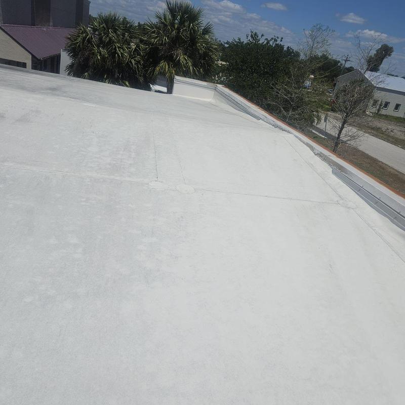 Flat commercial roof showing wear and seam repairs Flat commercial roof showing wear and seam repairs