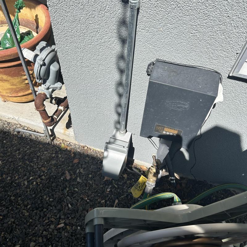 Gas meter and irrigation timer on exterior wall