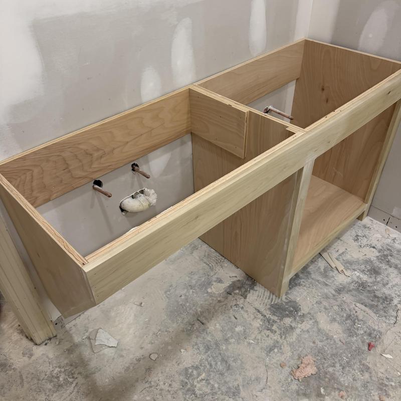 Wooden bathroom cabinet frame installation in remodel
