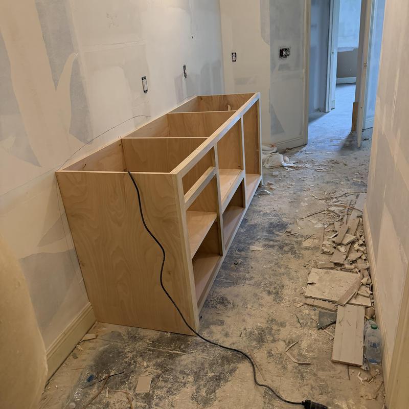 Wooden cabinet frame in remodel debris-filled hallway