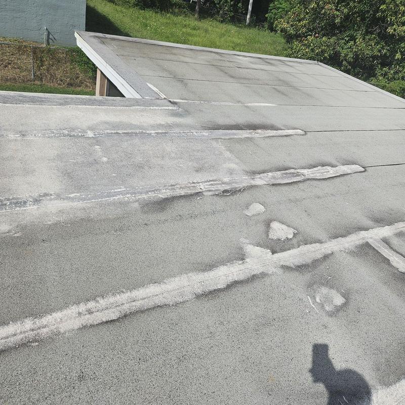 Flat roof with extensive wear and damaged seams Flat roof with extensive wear and damaged seams