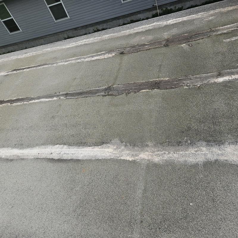 Flat roof membrane with extensive cracking and deterioration Flat roof membrane with extensive cracking and deterioration