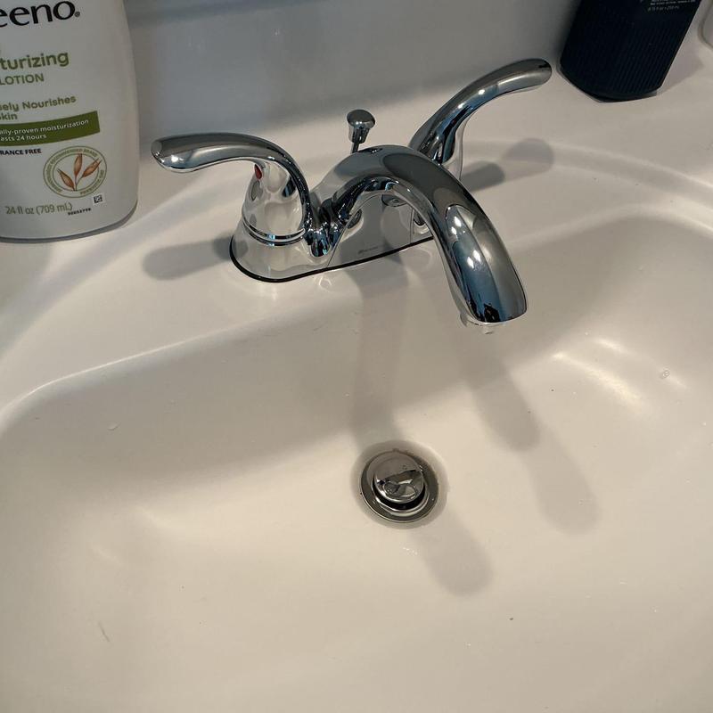 Chrome bathroom sink faucet with pop-up drain assembly