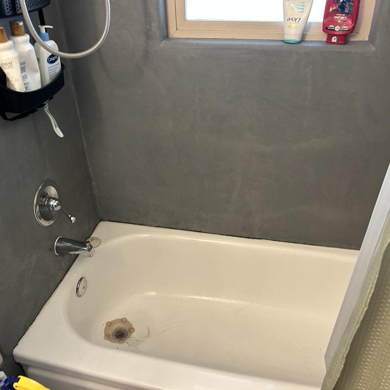 Shower handle and valve with corroded parts in bathtub