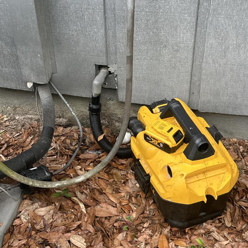 Condensate drain line with wet vacuum for clog cleaning Condensate drain line with wet vacuum for clog cleaning