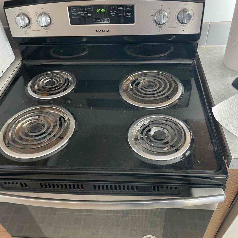 Electric stove with coil burners and control panel