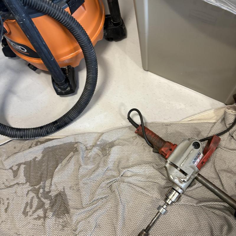 Drain cleaning machine and vacuum tools on floor Drain cleaning machine and vacuum tools on floor