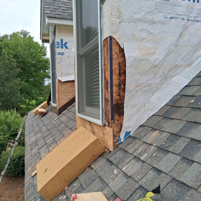 Siding replacement with rotten wood exposed on dormer