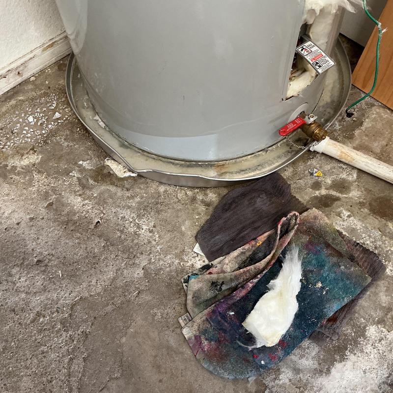 Water heater base with valve and floor debris