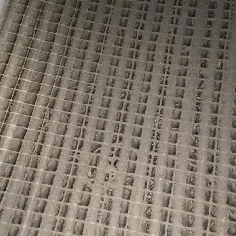 HVAC air filter clogged with dust buildup HVAC air filter clogged with dust buildup