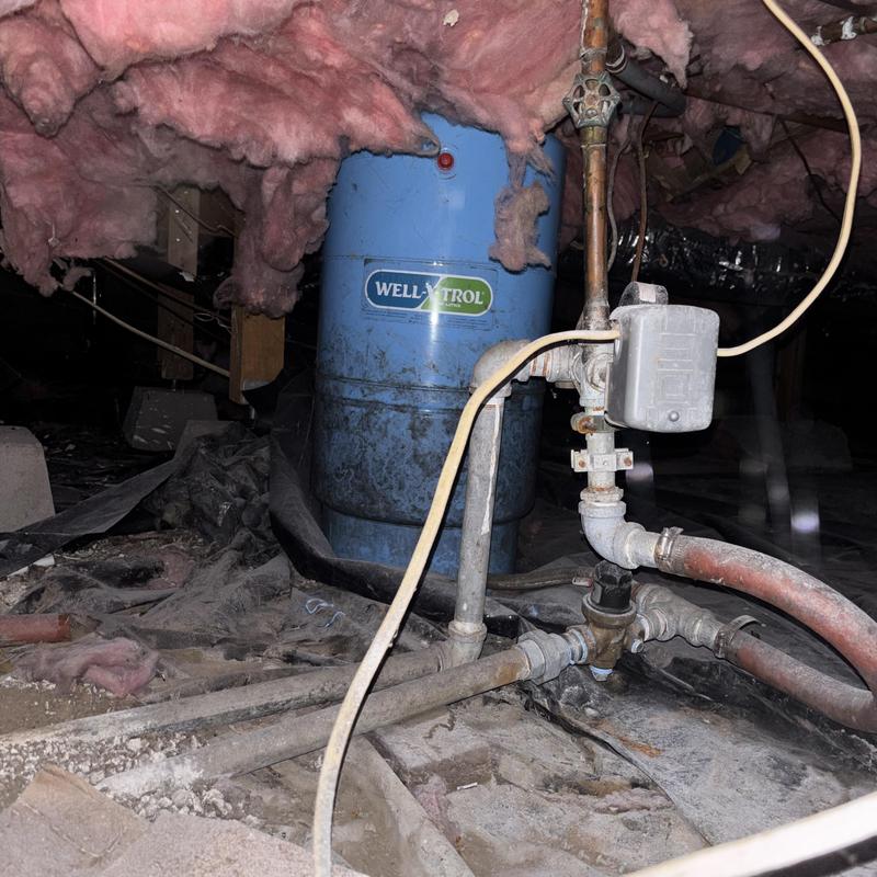 Well water pressure tank and main waterline in crawlspace