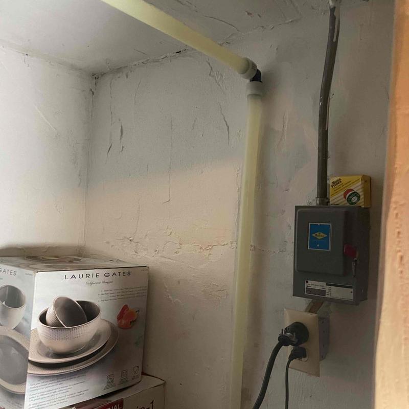 Electrical panel with conduit in basement corner Electrical panel with conduit in basement corner